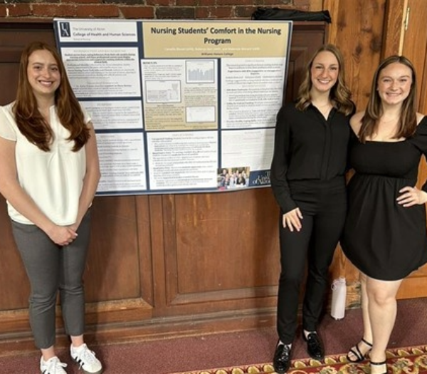 Nursing students with poster